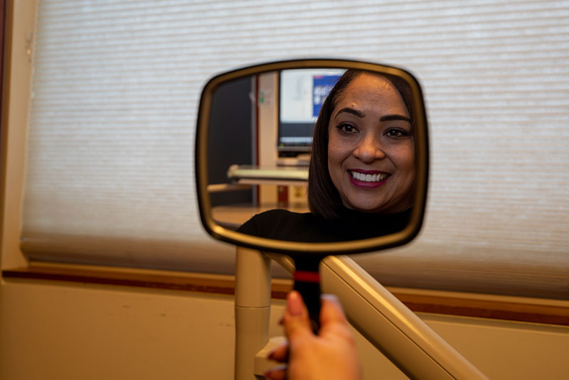 Patient smiling after their dental procedure