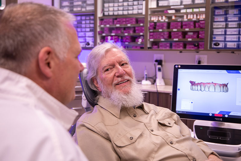 Patient and doctor going over information of dental procedure