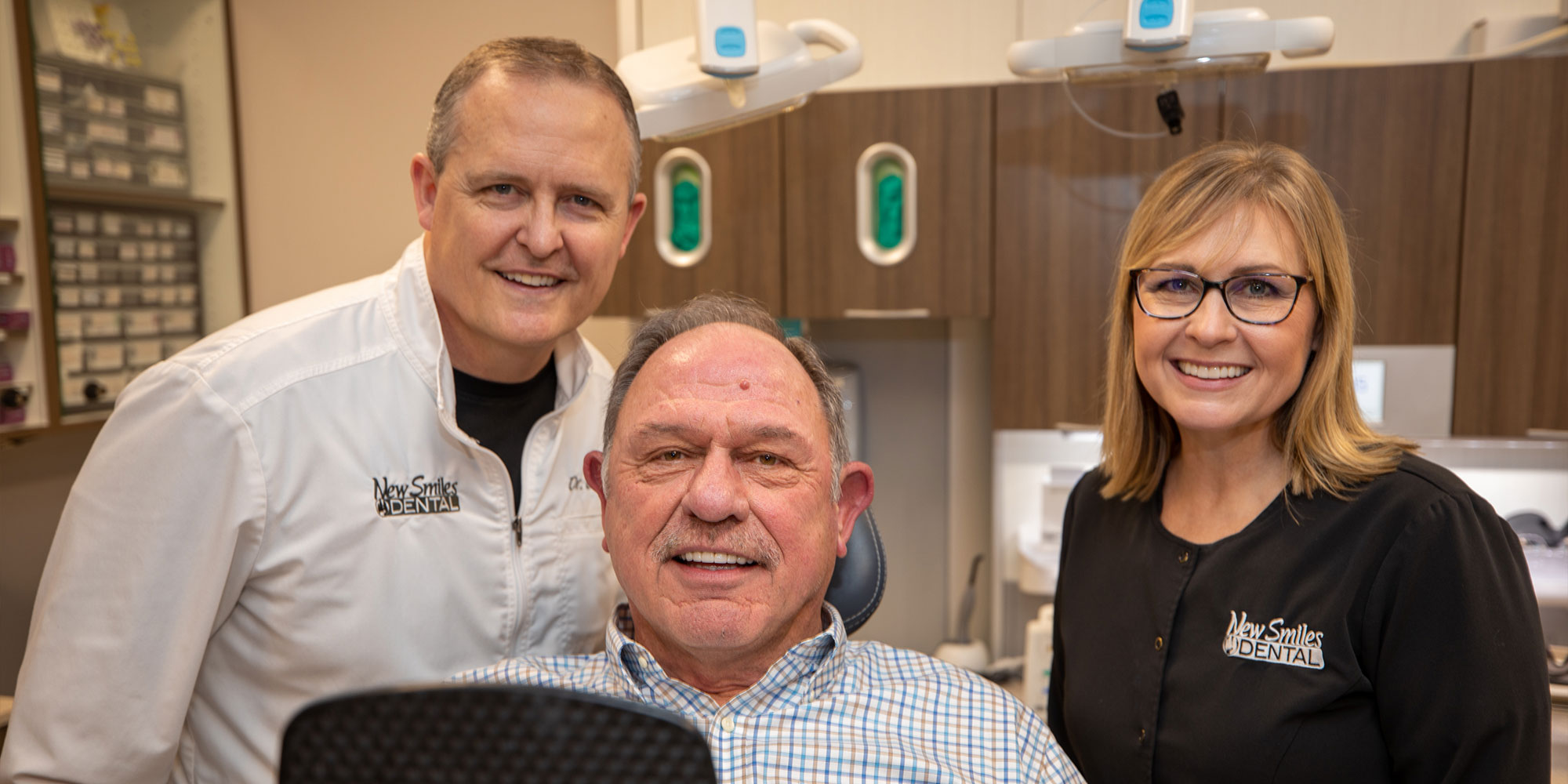 Doctors and staff-member smiling after dental procedure