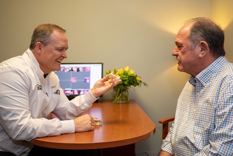 doctor and patient going over dental information for procedure.