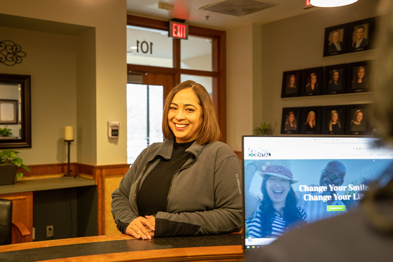 Patient interacting with staff member at front desk