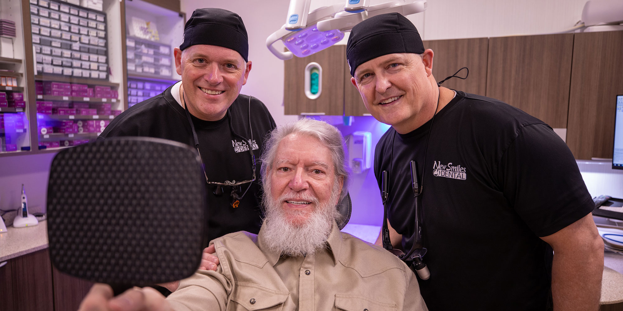 Doctors and patient smiling after dental procedure