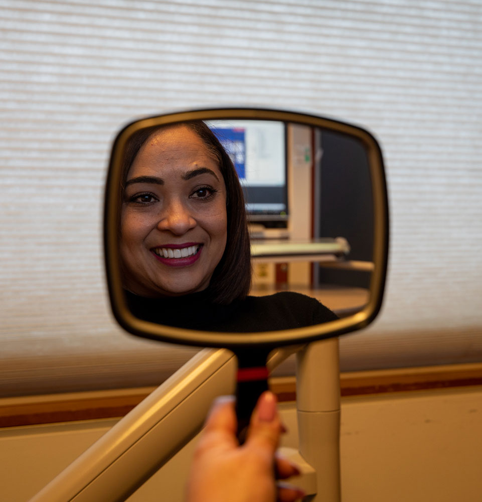 Patient smiling confidently after their dental procedure