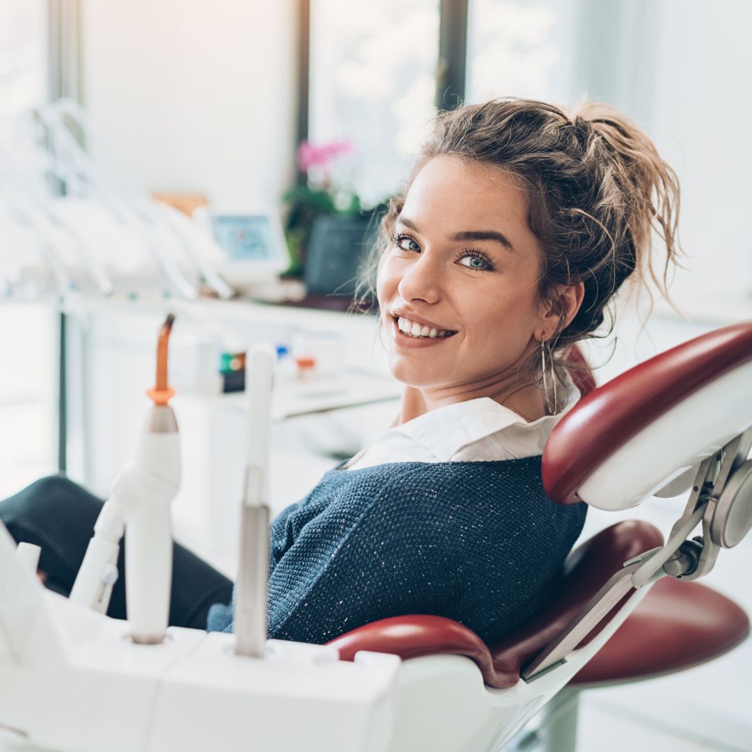 Dental Patient Sitting in Dental Chair Smiling