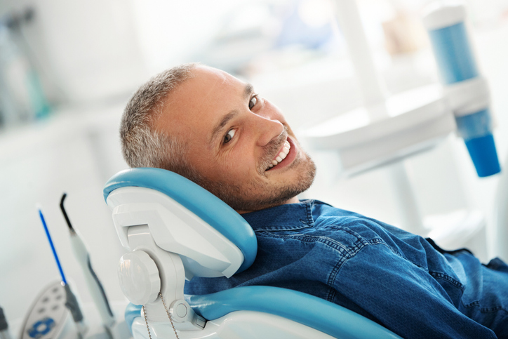 Dental Patient Smiling While Sitting in the Dental Chair