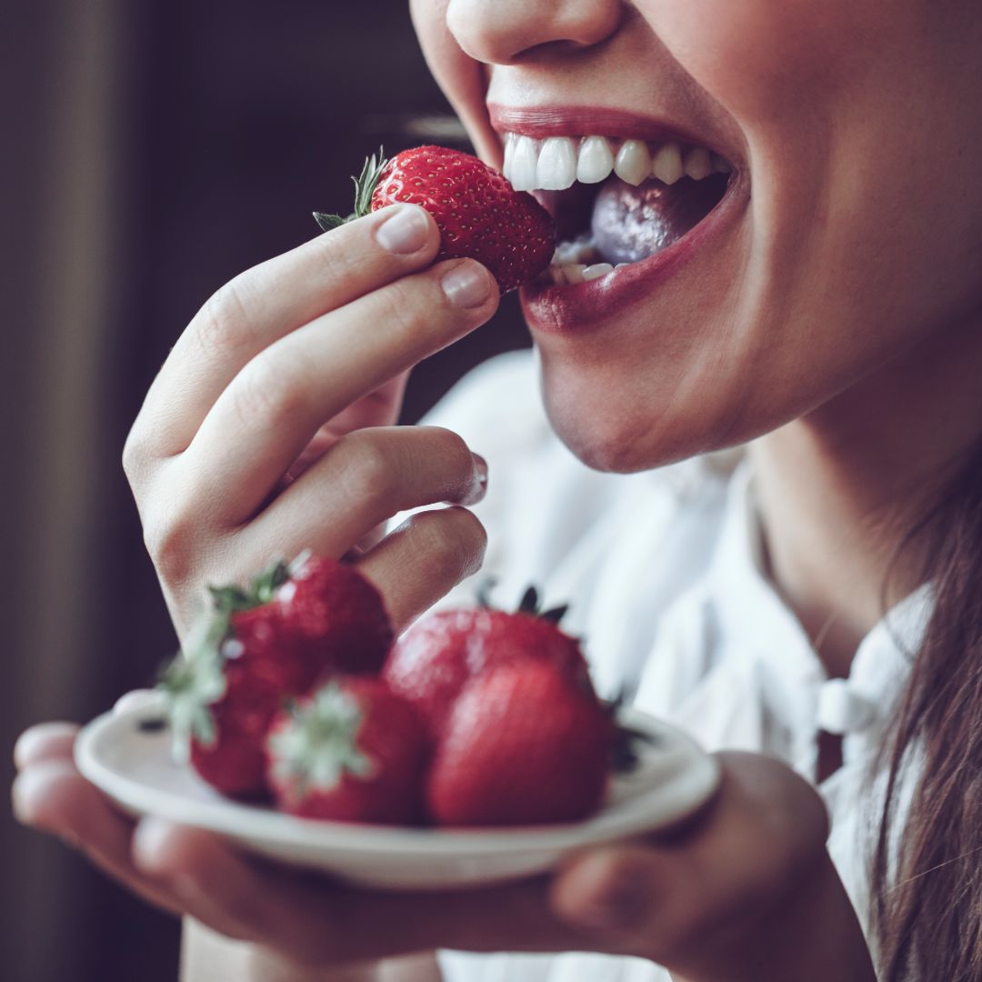 woman eating strawberries